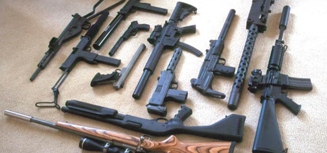 An image of firearms laid out on a table.