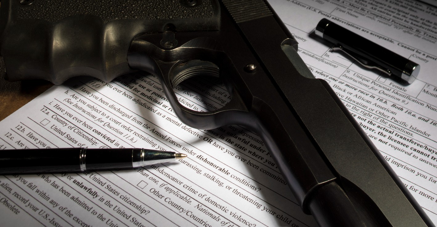 closeup-of-gun-and-registration-papers