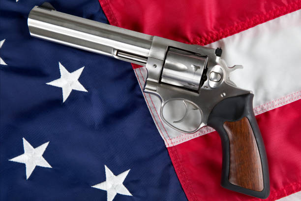 Image of a gun laying on the American flag.