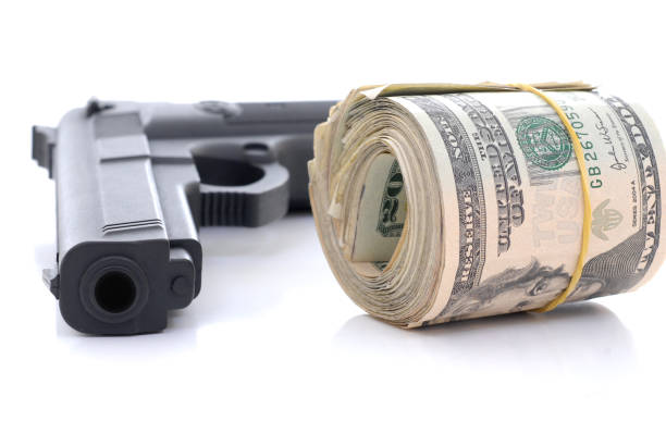 An image of a gun with money to represent the cost of an FFL.